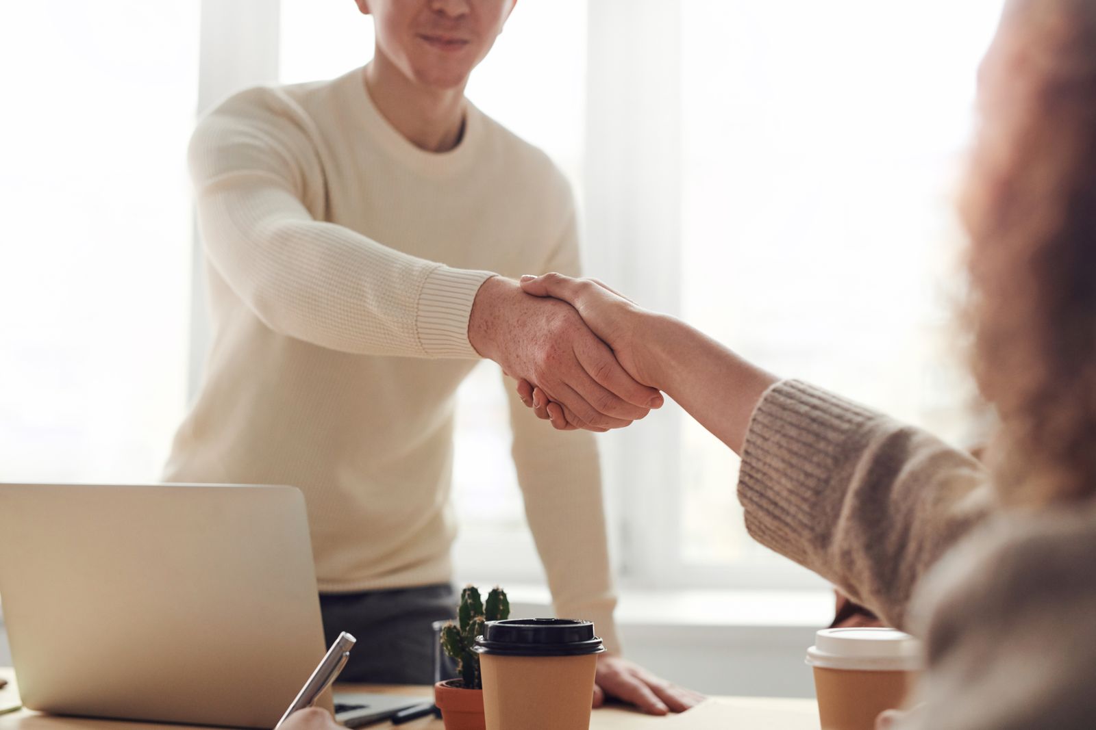Professionals shaking hands during a recruitment meeting